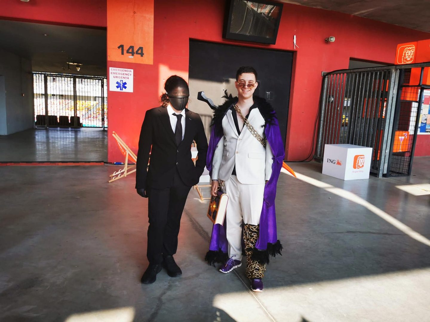 Alex in cosplay next to a masked cosplayer in a black suit